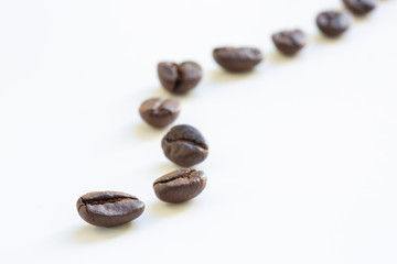 Curve of coffee beans on white background