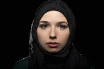 Female wearing a black hijab as a conservative fashion choice to represent feminist freedom of...