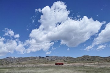 The galloping truck on the road in Bayinbulak grassland, Xinjiang of China