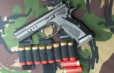 Firearm Pistol on military camouflage background - 140729604