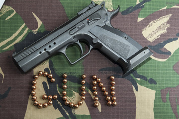 Firearm Pistol on military camouflage background - 140729657