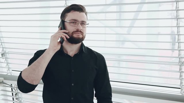 Young businessman looking out of window