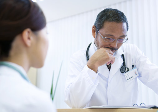Doctor looking at file with nurse