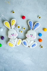 Decorated Easter Bunny Cookies Colorful Candies Chamomiles on a white background. Easter concept.