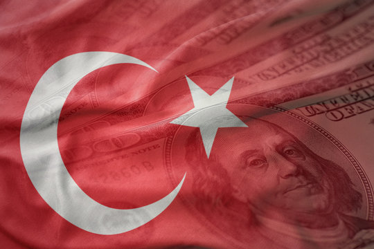 colorful waving national flag of turkey on a american dollar money background. finance concept