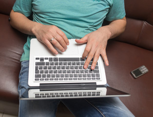 Fototapeta na wymiar Hands of a man on a laptop