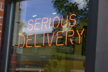 Restaurant Neon Delivery Sign in Window