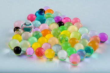 Heap of hydrogel balls lay on white background