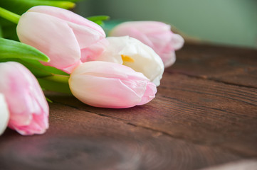 Rose-colored tulips on a wooden background. Copy Space and close up.