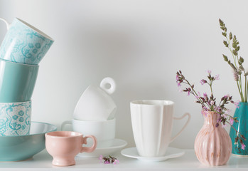 Clean dishes on white wooden shelf