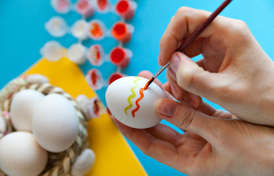 Person Painting Easter Eggs