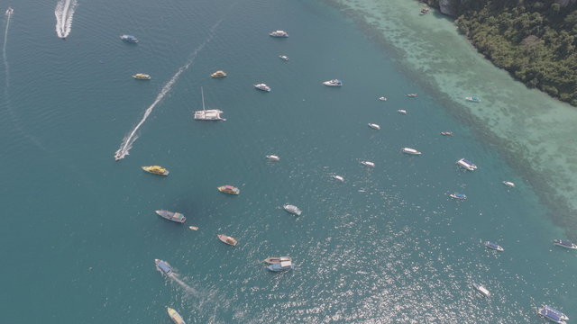 Aerial drone photo of sailing boats and yachts in the bay of iconic tropical Phi Phi island, Thailand