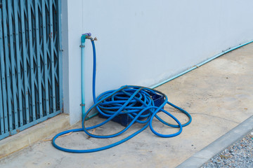 Garden hose or rubber tube on the concrete floor
