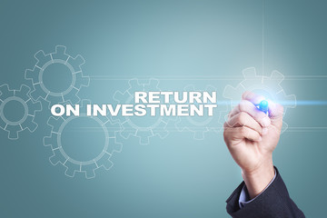 Businessman drawing on virtual screen. return on investment concept.