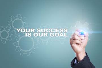 Businessman drawing on virtual screen. your success is our goal concept.