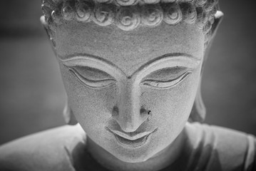 Ayutthaya, Thailand - March, 11, 2017 : Close up face of Buddha sandstone statue in Wat cheing len temple Thailand, Black and white picture.