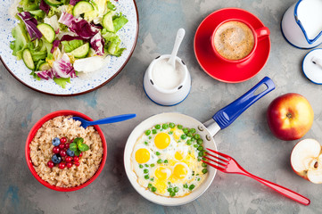 Salad with vegetables, eggs, oatmeal porridge, croissants and coffee. Breakfast concept. Top view