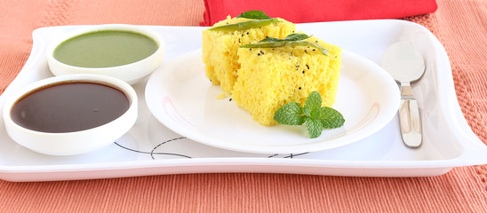 Dhokla, an Indian vegetarian food native to Gujarat state, India, in a plate.