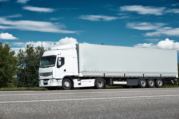 White truck on road with blue sky, cargo transportation concept