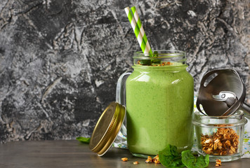 Detox drink - Green smoothie with spinach, mint, yogurt and granola for breakfast. Metallic background. Organic food.