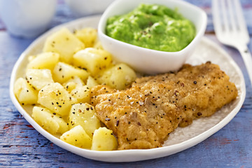 Battered haddock, potatoes with pea puree