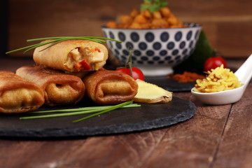 Crispy golden fried spring rolls with fresh ingredients served in an oriental restaurant