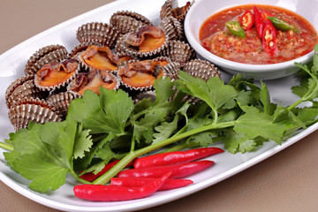 Soft-boiled blood cockles shell  served with spicy sauce.