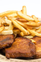 Stewed pork chops with french fries on the plate