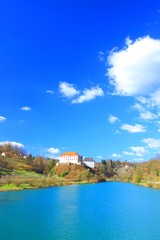 Fototapeta na wymiar River Kupa and Castle on hill, Ozalj in Croatia, blue sky with clouds in background