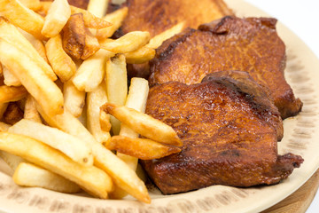 Closeup macro baked pork chops on the plate