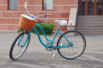 Fototapeta premium Retro blue women's bicycle with basket in front outdoor