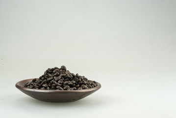 Fototapeta na wymiar closeup of coffee beans in wooden spoon.