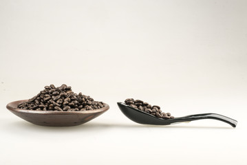 closeup of coffee beans  in wooden spoon.