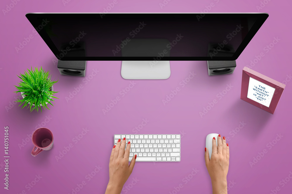 Poster Top view work desk scene with computer display, keyboard, and mouse. Woman typing and use mouse. Free space for text. Pink desk.