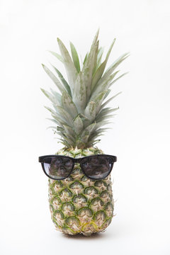 the big pineapple in sunglasses on white background