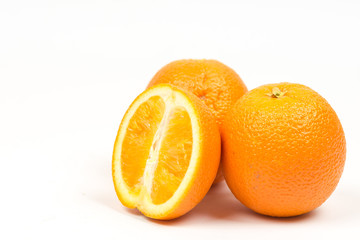 Three sliced oranges isolated over white background