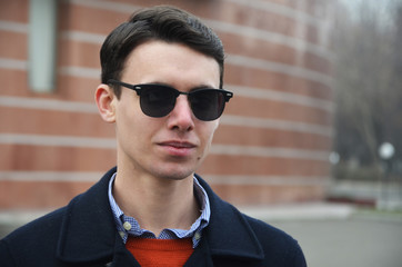 Young business man in glasses ouside