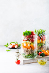 Homemade salad in glass jar with quinoa and vegetables. Healthy food, diet, detox, clean eating and vegetarian concept with copy space.