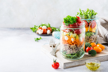 Homemade salad in glass jar with quinoa and vegetables. Healthy food, diet, detox, clean eating and vegetarian concept with copy space.