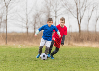 Kids soccer football - children players match on soccer field