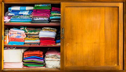 Closet with clothes folded in orderly