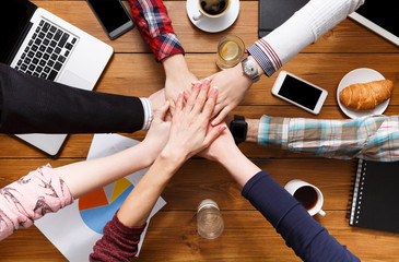 Teamwork and teambuilding concept in office, people connect hands