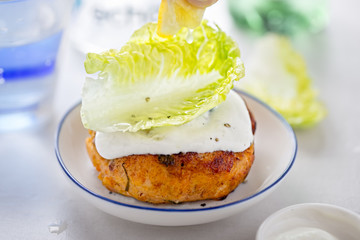 Salmon fishcake burger with mayo and lettuce