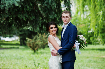 Happy stylish loved couple in love at green spring background.