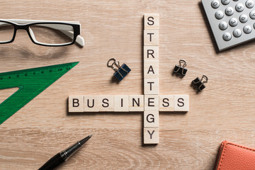 Conceptual business keywords on table with elements of game making crossword