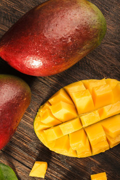 Some mango on wooded board.
