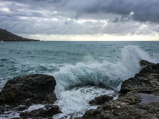 Big waves breaking on the shore with sea foam