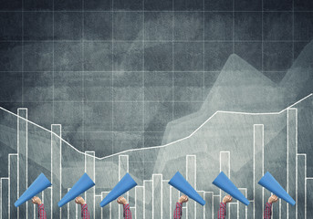 female hands in a row holding blue paper trumpets against graphs background