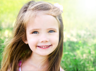 Cute smiling little girl on the meadow