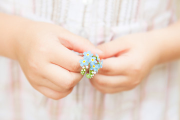 Spring - Forget me not flowers in little child's hands